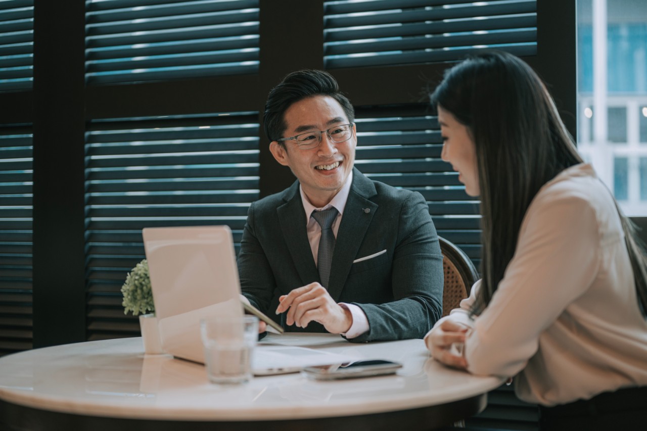 Asian chinese businessman discussion with his client in cafe